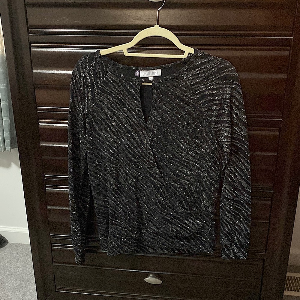 Black top with shiny silver accents with keyhole tops and wrap accent at waist
